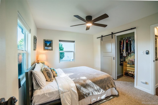 332 Maple Dr, Frederick, CO 80530 - carpeted bedroom with a barn door, multiple windows, a closet, and ceiling fan