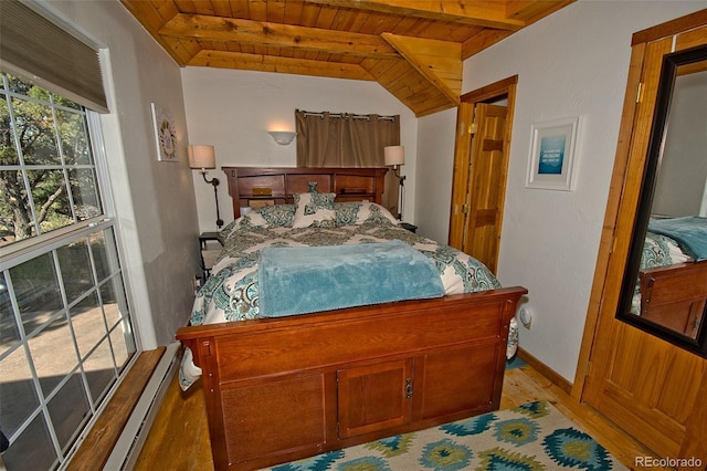 bedroom featuring vaulted ceiling with beams, wood ceiling, baseboard heating, and light wood-type flooring