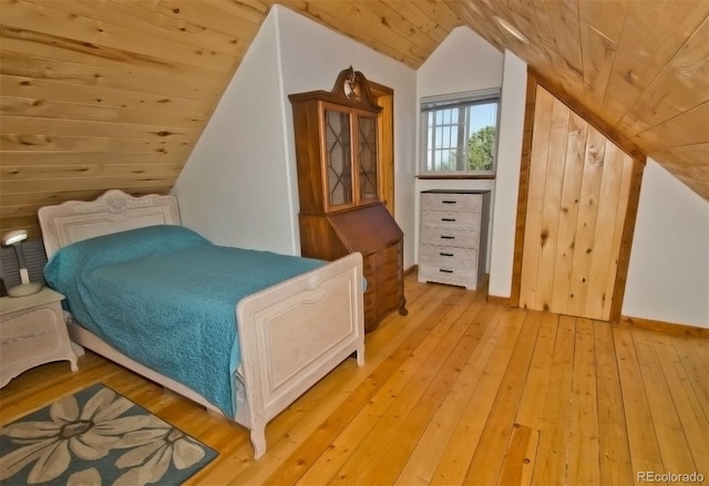 bedroom featuring light wood-type flooring, wood walls, wooden ceiling, and lofted ceiling