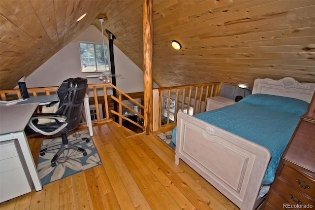 bedroom with wood ceiling, light hardwood / wood-style flooring, and vaulted ceiling