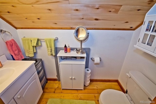 bathroom with vanity, wooden ceiling, hardwood / wood-style flooring, and toilet