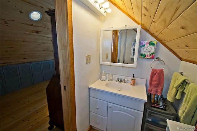 bathroom with vanity, wood ceiling, wood-type flooring, and lofted ceiling