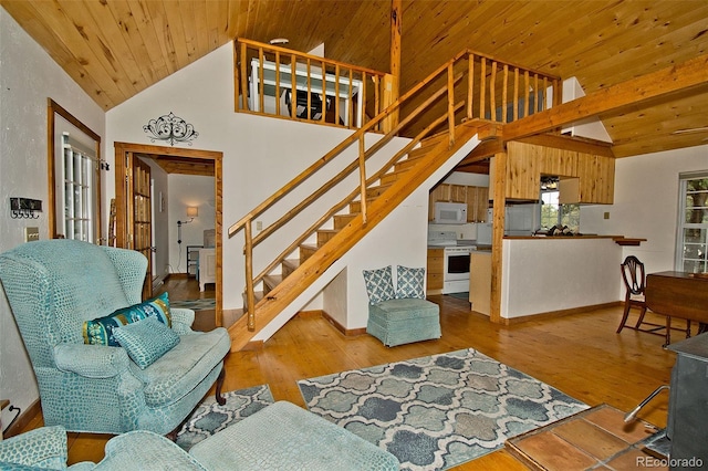living room with stairs, baseboards, wooden ceiling, wood finished floors, and vaulted ceiling