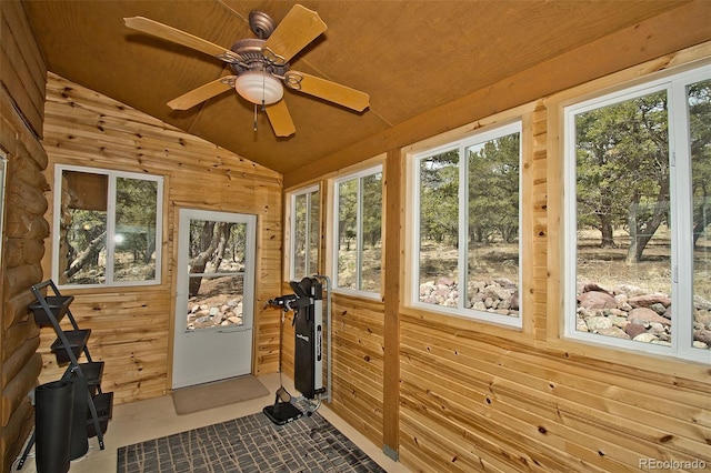sunroom with wood walls and lofted ceiling