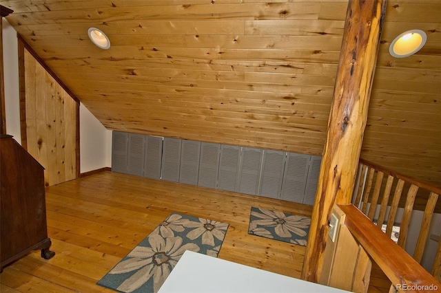 bonus room with wood-type flooring, lofted ceiling, wooden walls, and wooden ceiling