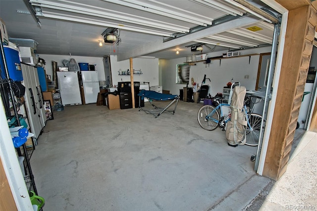 garage with freestanding refrigerator and a garage door opener