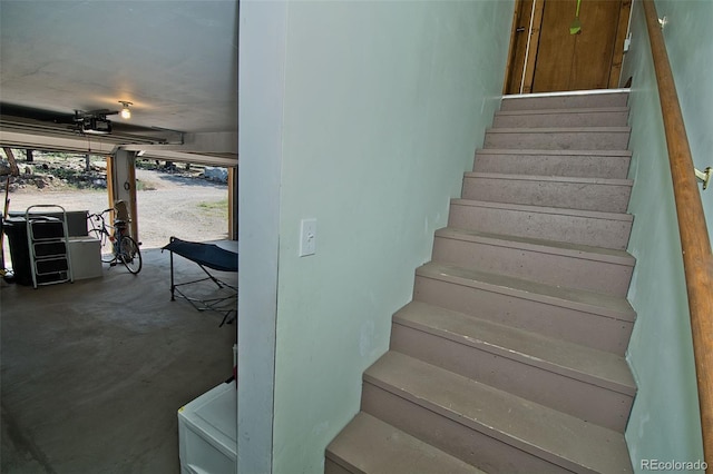 stairs featuring unfinished concrete floors