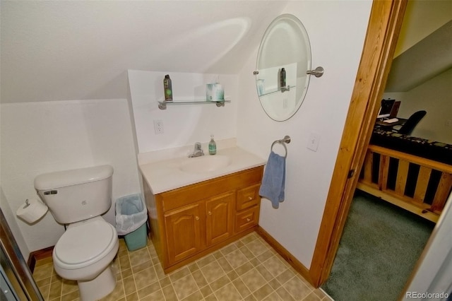 bathroom with toilet, baseboards, vaulted ceiling, and vanity
