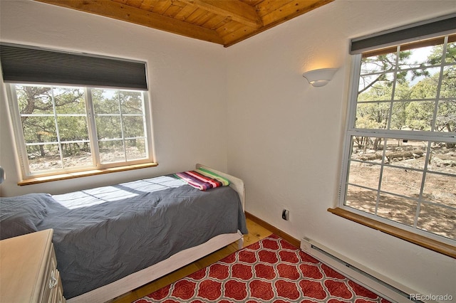bedroom featuring wooden ceiling, a baseboard radiator, beam ceiling, and wood finished floors
