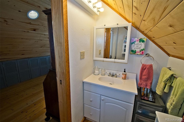 bathroom with wooden ceiling, wood finished floors, lofted ceiling, and vanity