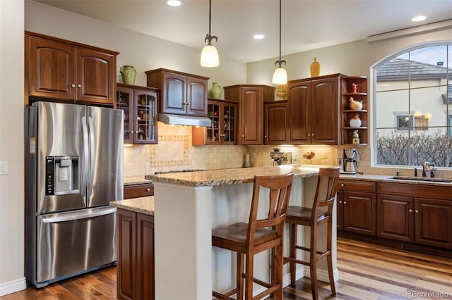 5055 Mcclure Ln, Castle Rock, CO 80108 - kitchen featuring stainless steel fridge with ice dispenser, a sink, dark wood-type flooring, under cabinet range hood, and open shelves