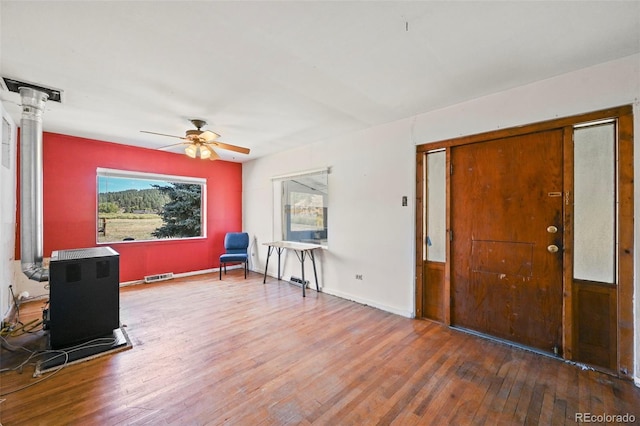 entryway with dark hardwood / wood-style flooring and ceiling fan