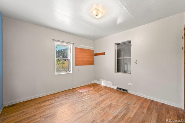 unfurnished room with light hardwood / wood-style flooring