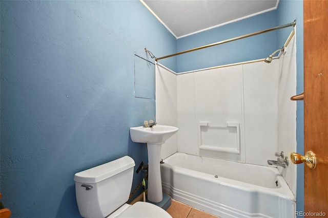 bathroom featuring toilet, shower / washtub combination, and tile patterned floors