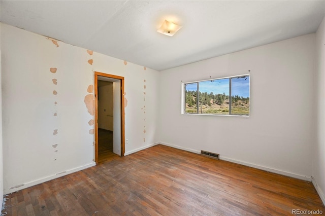 unfurnished bedroom featuring dark hardwood / wood-style floors