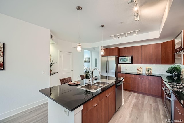 2240 N Clay St Unit 406, Denver, CO 80211 - kitchen with appliances with stainless steel finishes, a sink, modern cabinets, light wood finished floors, and dark countertops