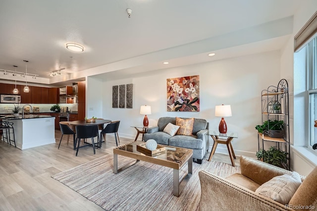2240 N Clay St Unit 406, Denver, CO 80211 - living room featuring track lighting, light wood-style floors, baseboards, and recessed lighting