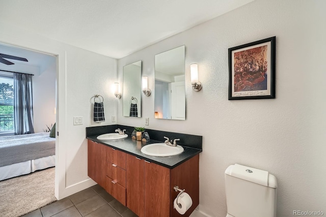 2240 N Clay St Unit 406, Denver, CO 80211 - ensuite bathroom with double vanity, tile patterned flooring, toilet, and baseboards