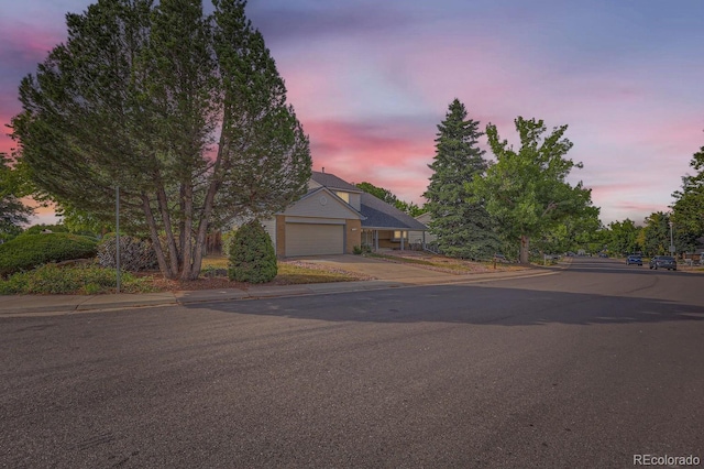 view of front of home featuring concrete driveway and an attached garage