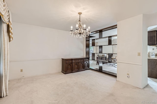 spare room featuring carpet, floor to ceiling windows, and a chandelier