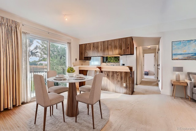 dining area featuring light wood-style floors