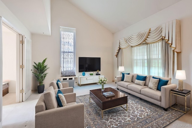 carpeted living room featuring high vaulted ceiling