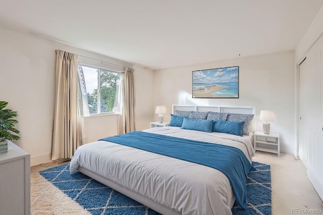 bedroom featuring light colored carpet