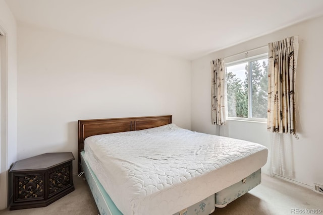 bedroom with visible vents and carpet flooring