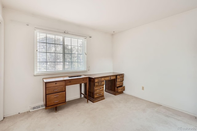 office space with visible vents and light colored carpet