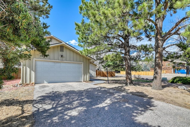 6486 Hawkeye Cir, Colorado Springs, CO 80919 - exterior space with board and batten siding, driveway, a garage, and fence