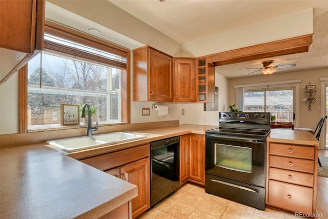 6486 Hawkeye Cir, Colorado Springs, CO 80919 - kitchen with light countertops, a sink, a peninsula, and black appliances