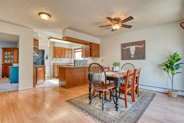 6486 Hawkeye Cir, Colorado Springs, CO 80919 - dining area featuring a ceiling fan, light wood finished floors, and a textured ceiling