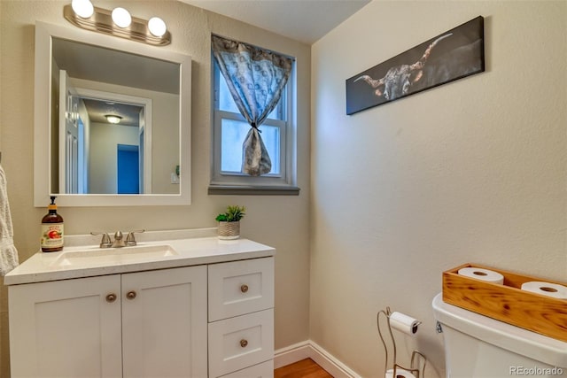 6486 Hawkeye Cir, Colorado Springs, CO 80919 - half bathroom with toilet, vanity, and baseboards