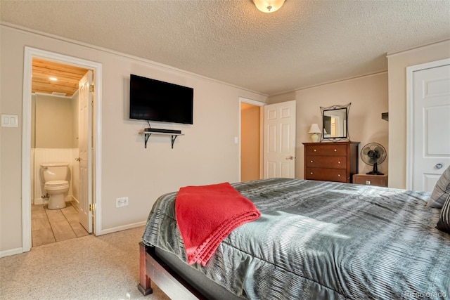 6486 Hawkeye Cir, Colorado Springs, CO 80919 - carpeted bedroom with baseboards, a textured ceiling, and connected bathroom