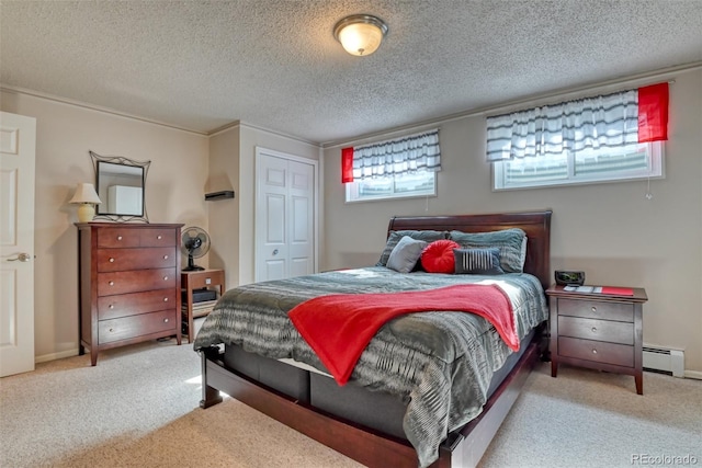 6486 Hawkeye Cir, Colorado Springs, CO 80919 - carpeted bedroom featuring a baseboard radiator, a closet, baseboards, and a textured ceiling