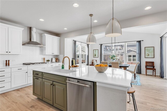 821 Boulder Peak Ave, Erie, CO 80516 - kitchen with wall chimney exhaust hood, a sink, dishwasher, white cabinets, and backsplash