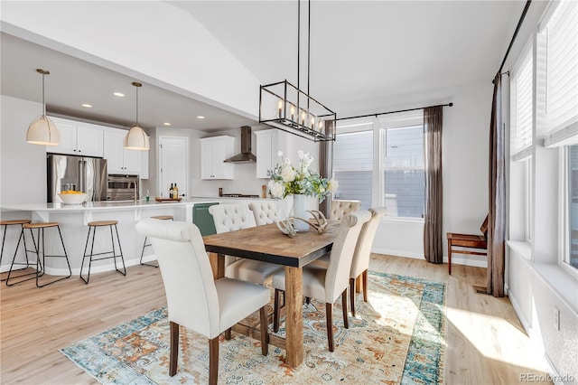 821 Boulder Peak Ave, Erie, CO 80516 - dining area with light wood-style floors, recessed lighting, a chandelier, and vaulted ceiling