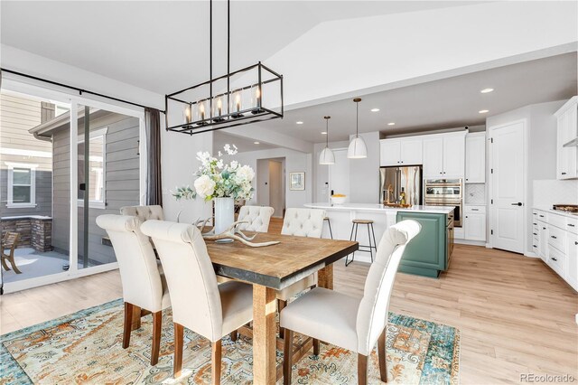 821 Boulder Peak Ave, Erie, CO 80516 - dining space with light wood-style flooring, a chandelier, recessed lighting, and lofted ceiling