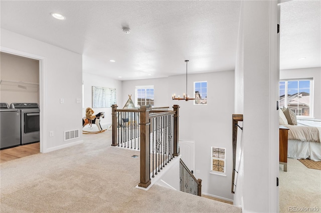 821 Boulder Peak Ave, Erie, CO 80516 - staircase featuring separate washer and dryer, carpet flooring, a chandelier, baseboards, and recessed lighting