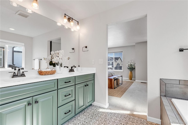 821 Boulder Peak Ave, Erie, CO 80516 - full bath with double vanity, baseboards, and a tub to relax in