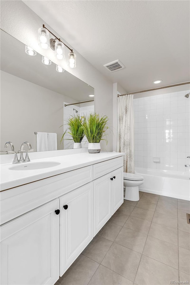 821 Boulder Peak Ave, Erie, CO 80516 - full bathroom with tile patterned floors, toilet, vanity, shower / bath combo, and a textured ceiling