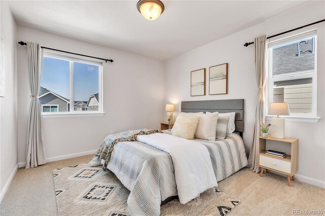 821 Boulder Peak Ave, Erie, CO 80516 - bedroom with light carpet and baseboards