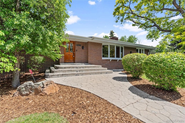 2520 Eldridge Cir, Golden, CO 80401 - view of front of house with brick siding and a chimney