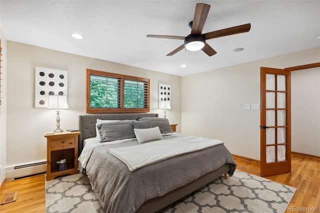 2520 Eldridge Cir, Golden, CO 80401 - bedroom featuring a baseboard heating unit, light wood-type flooring, a ceiling fan, and recessed lighting