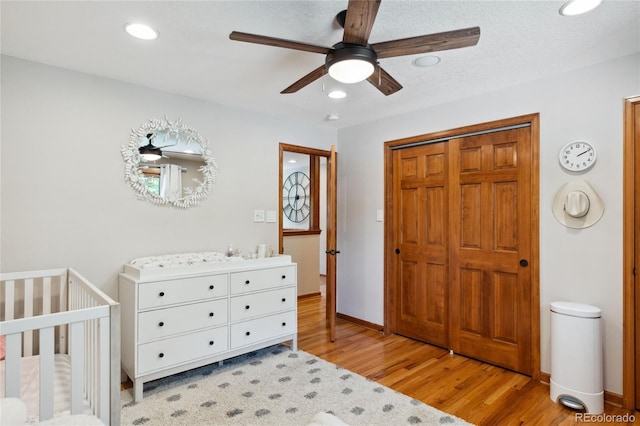 2520 Eldridge Cir, Golden, CO 80401 - bedroom featuring light wood-style floors, recessed lighting, ceiling fan, a closet, and a crib