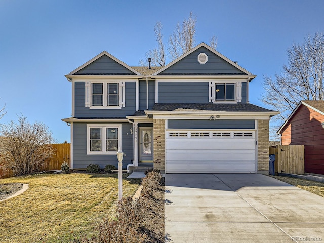 traditional home featuring brick siding, an attached garage, fence, driveway, and a front lawn