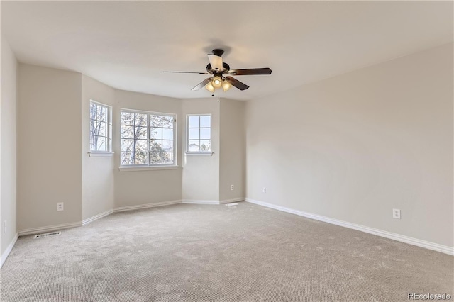 spare room featuring ceiling fan and carpet flooring