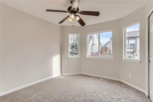 unfurnished room with ceiling fan and light carpet