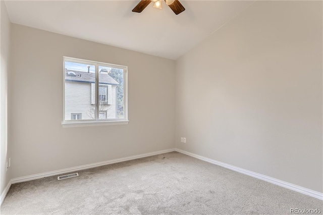 carpeted empty room featuring ceiling fan and vaulted ceiling