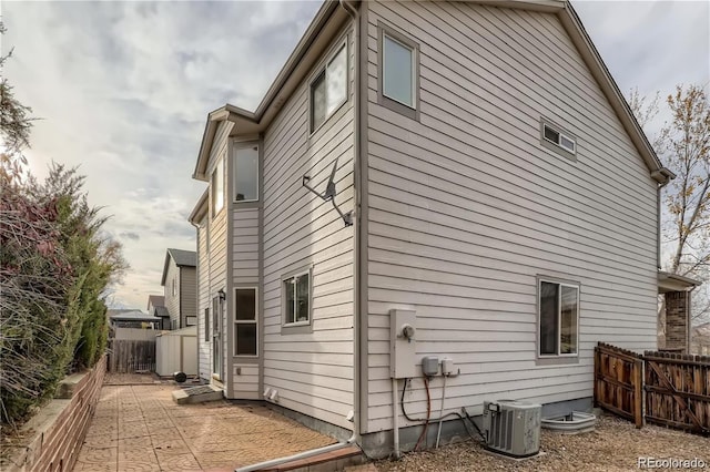 view of side of home with a patio and cooling unit